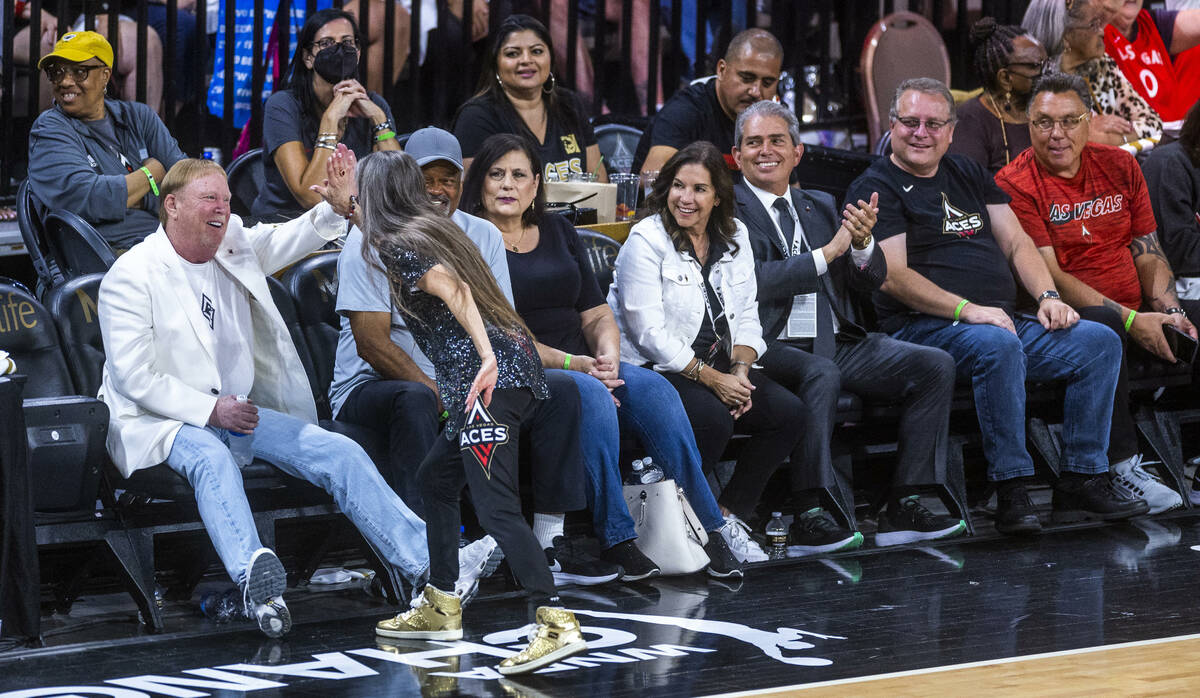 Raiders owner Mark Davis gets a "high five" from a High Rollers dancer during the sec ...