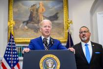 President Joe Biden speaks as Secretary of Education Miguel Cardona looks on after Biden announ ...