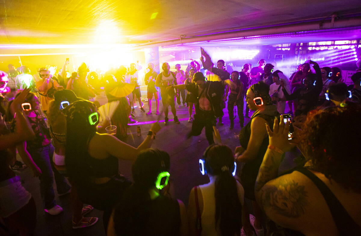 Attendees dance as Wizdumb performs in a silent disco at the 7-Eleven Brainfreeze Garage during ...
