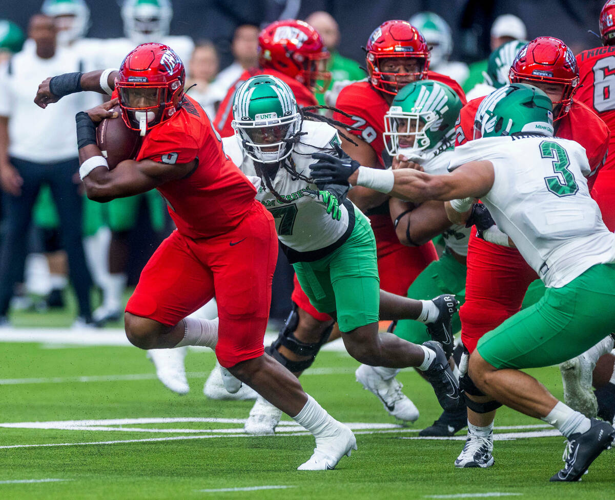 UNLV Rebels running back Aidan Robbins (9) breaks into the open past North Texas Mean Green lin ...