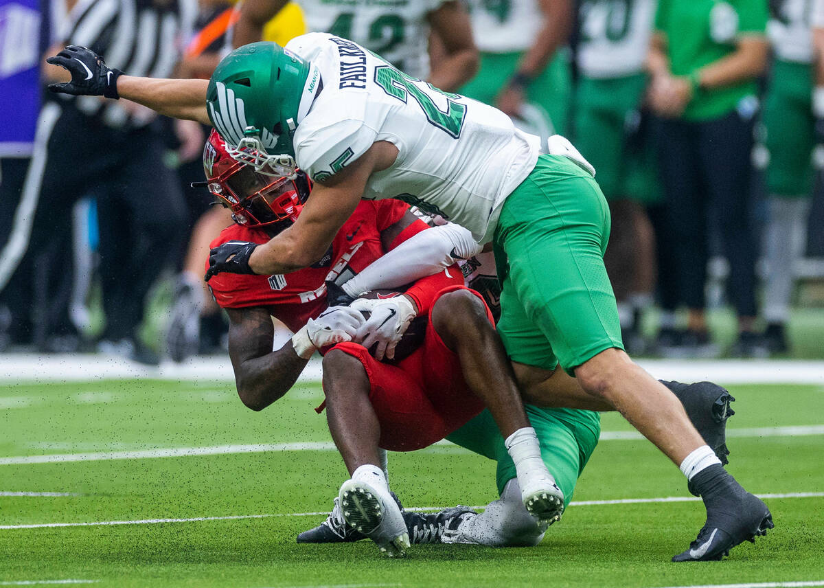 UNLV Rebels wide receiver Kyle Williams (1) take a targeting hit from North Texas Mean Green li ...