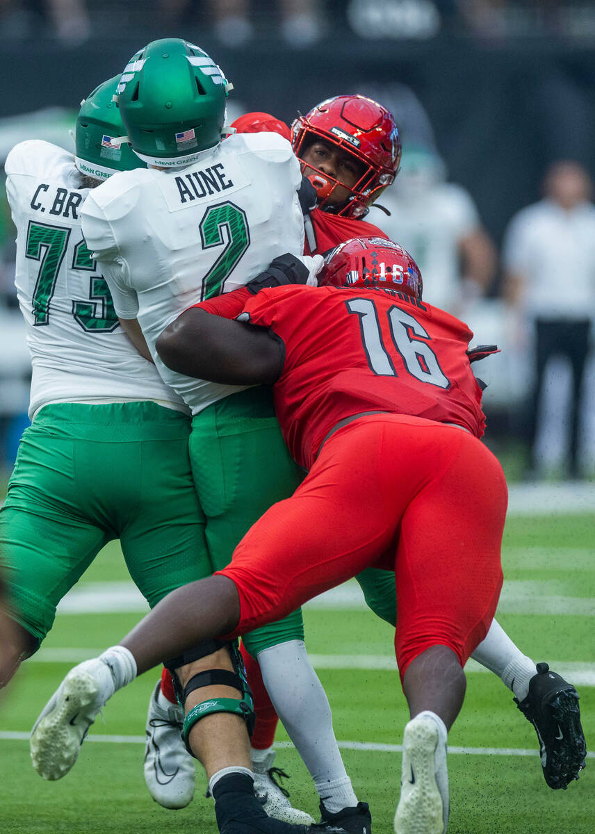 North Texas Mean Green quarterback Austin Aune (2) is caught from behind by UNLV Rebels defensi ...
