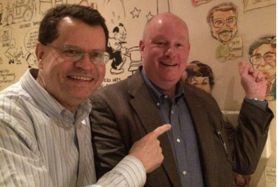 Larry Henry and Steve Sebelius pointing to the caricature of Jeff on the wall at the Palm in Ca ...