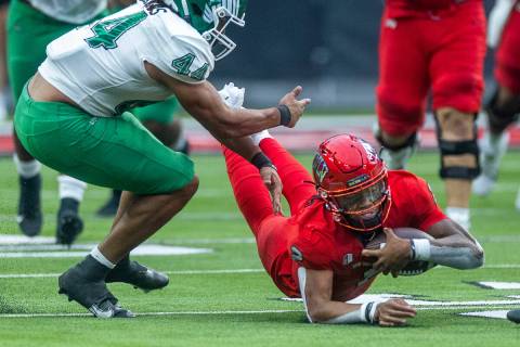 UNLV Rebels quarterback Doug Brumfield (2) dives for a few more yards beside North Texas Mean G ...
