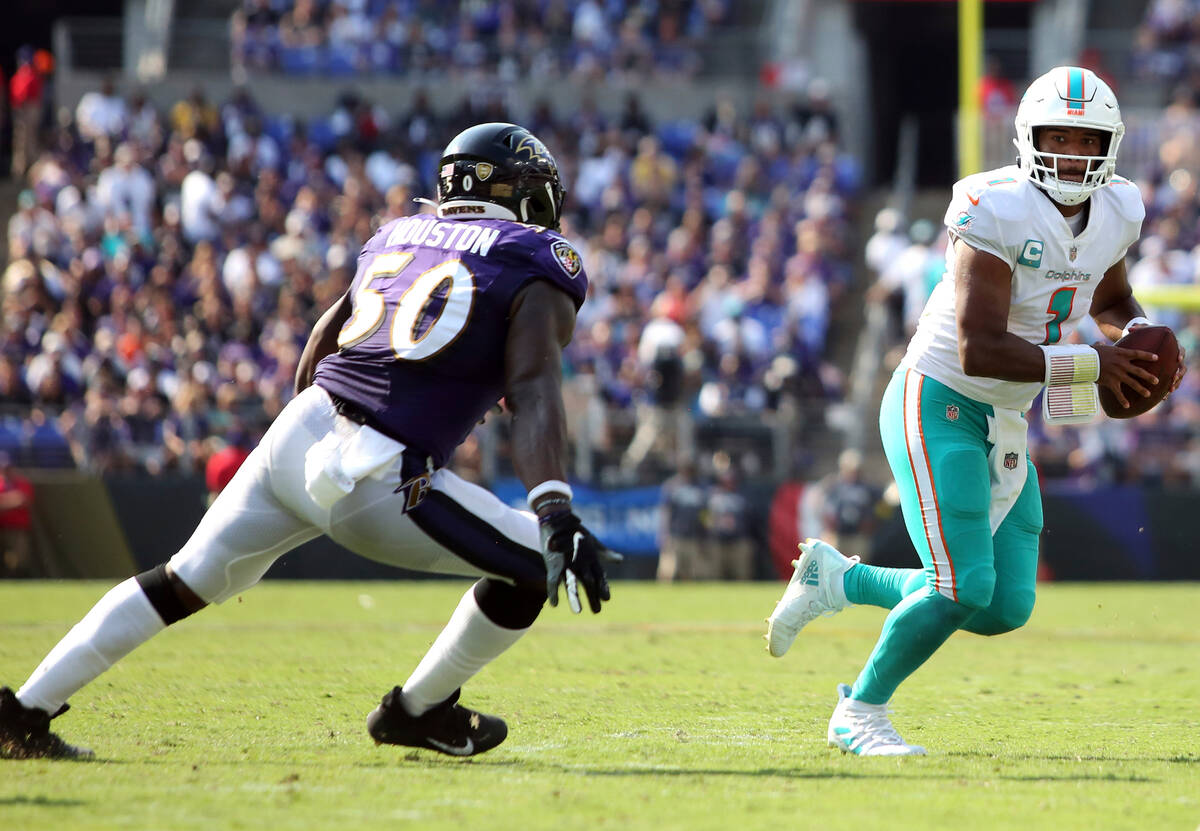 Miami Dolphins quarterback Tua Tagovailoa (1) runs during an NFL football game against the Balt ...
