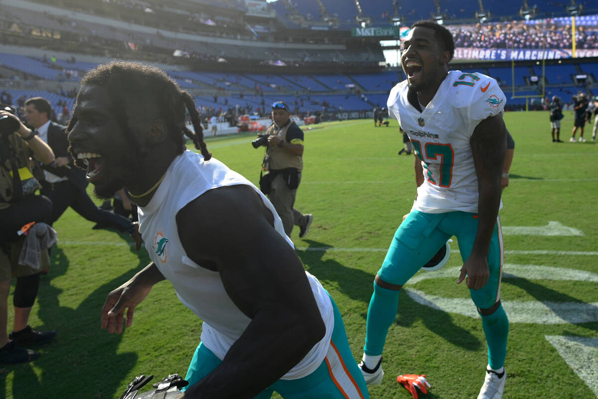 Miami Dolphins wide receivers Tyreek Hill, foreground, and Jaylen Waddle (17) celebrate at the ...