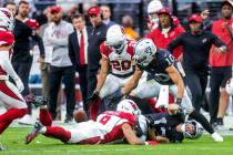 Raiders wide receiver Hunter Renfrow (13) fumbles the ball after a big hit from Arizona Cardina ...