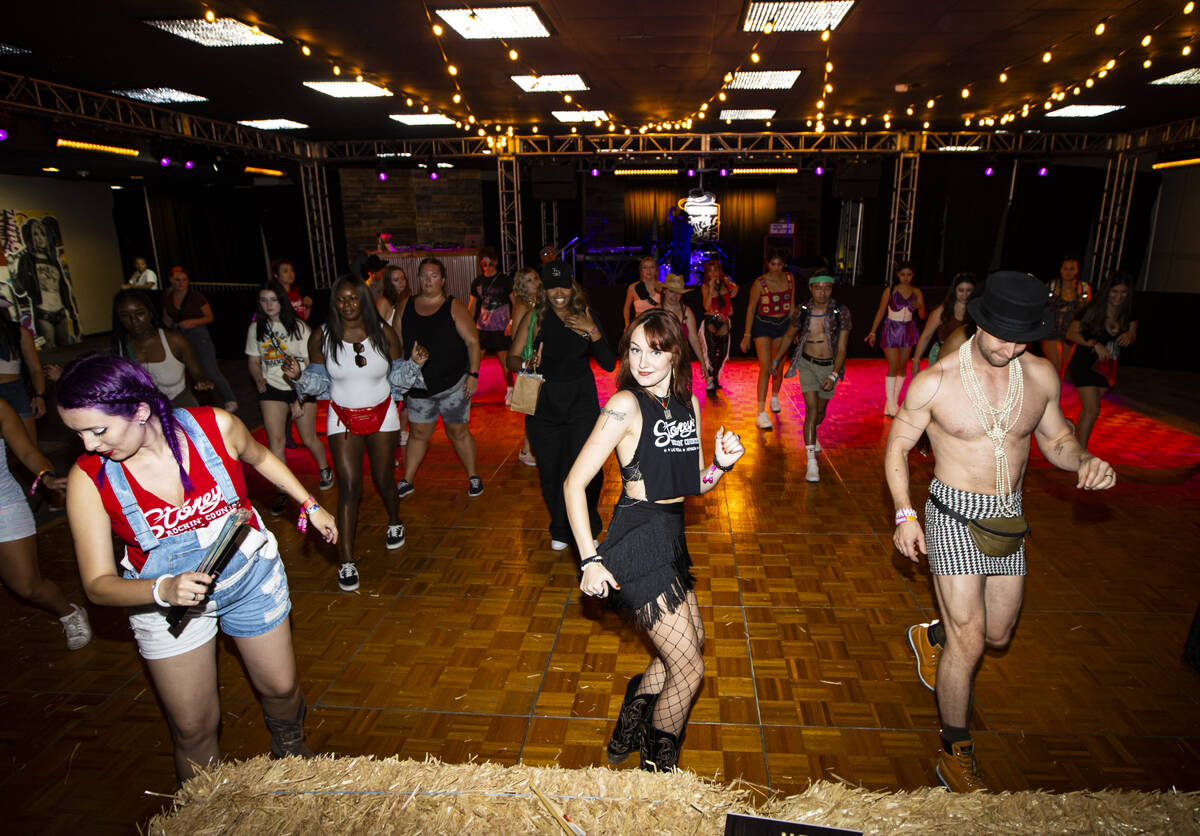 Attendees line dance at the Western Country Club during the Life is Beautiful festival on Sunda ...