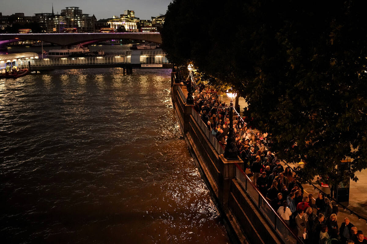 People wait in line to pay tribute to Queen Elizabeth II in London, Sunday, Sept. 18, 2022. The ...