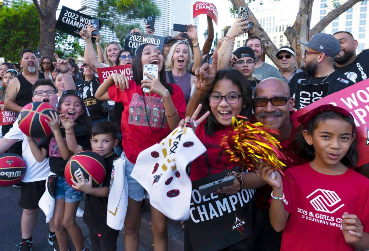 Fans watch as the Las Vegas Aces pass by during the team's WNBA Championship victory parade on ...