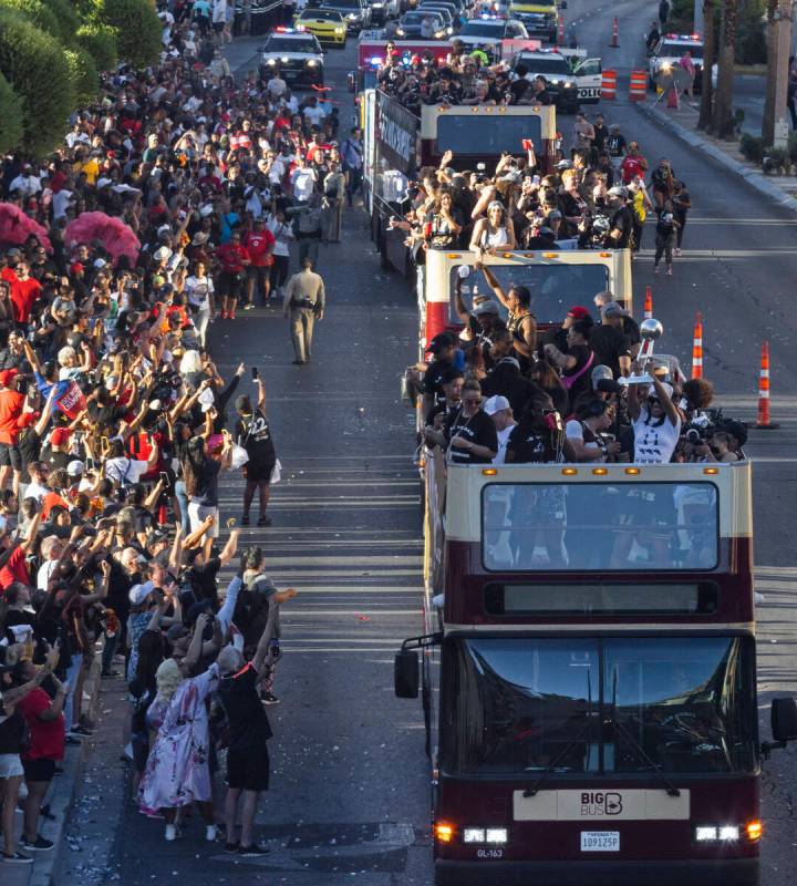 Fans watch as the Las Vegas Aces pass by during the team's WNBA Championship victory parade on ...