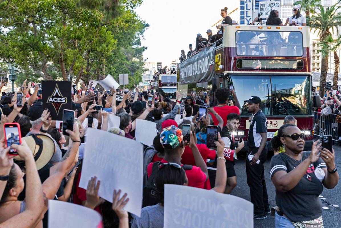 Fans watch as the Las Vegas Aces pass by during the team's WNBA Championship victory parade on ...