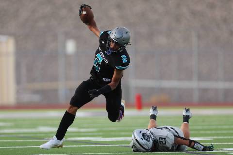 Silverado's Donavyn Pellot (2) dodges a tackle by Palo Verde's Blair Thayer (23) during the fir ...