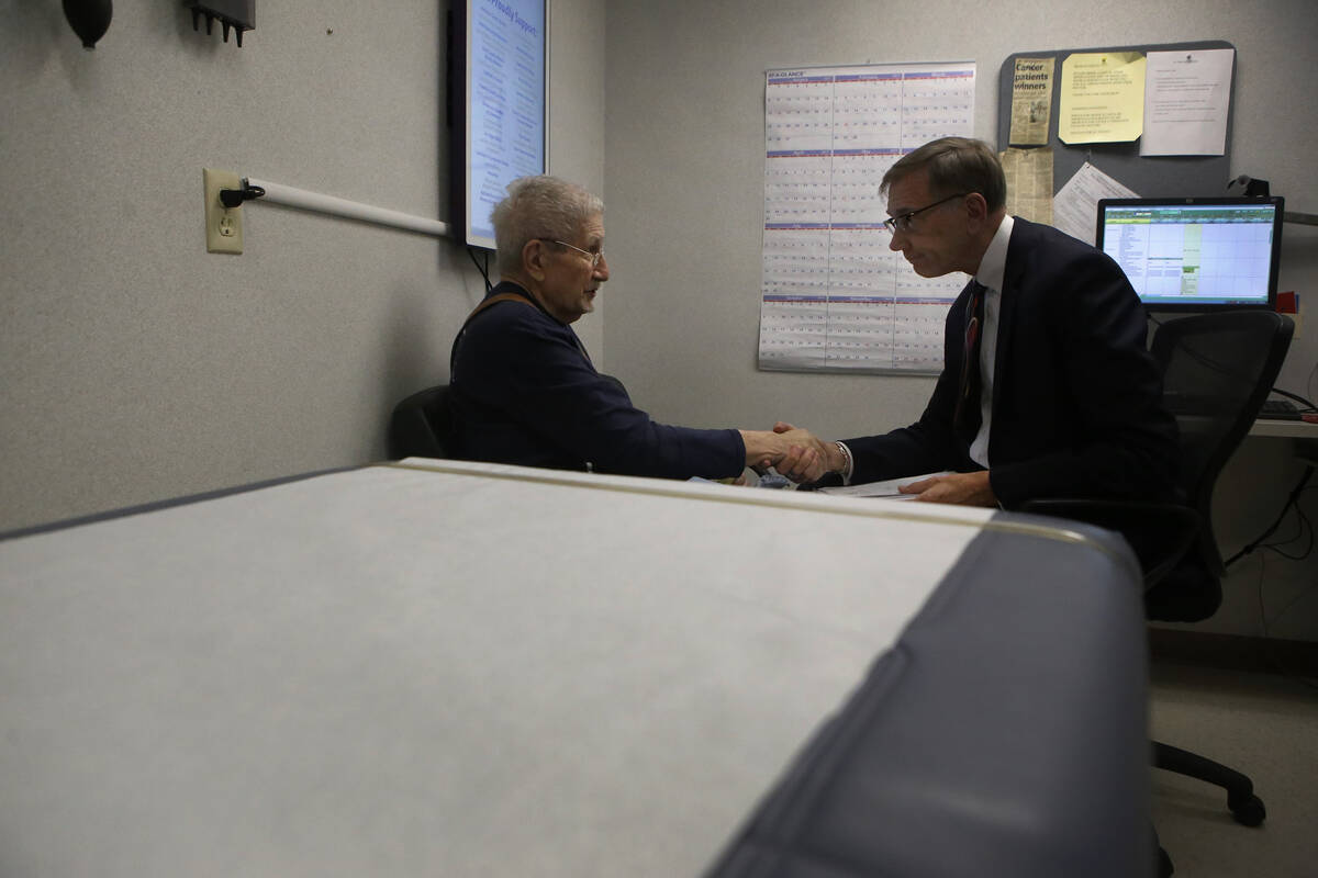 Terry Vantaggi, 74, left, shakes Dr. Nicholas Vogelzang hand after an appointment at the Compre ...