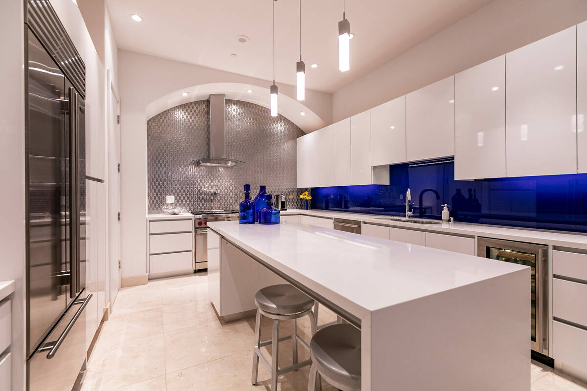 The kitchen features a large island with seating. (Coldwell Banker Premier)