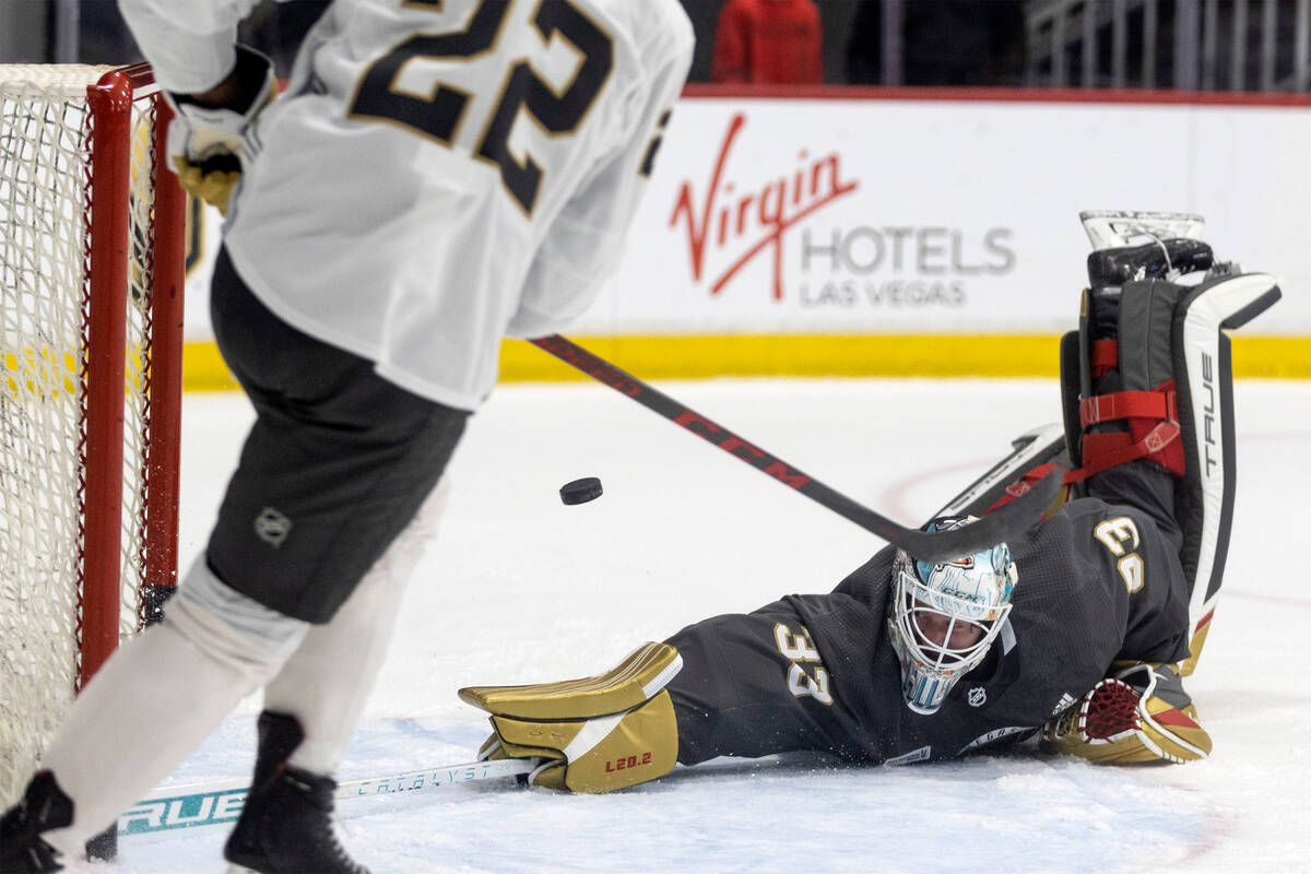 Golden Knights forward Michael Amadio (22) shoots while goaltender Adin Hill (33) dives to save ...