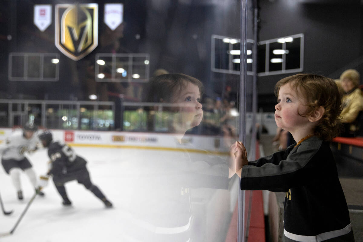 Wolf Dyal, 1, watches the Vegas Golden Knights on the ice for the first time during training ca ...