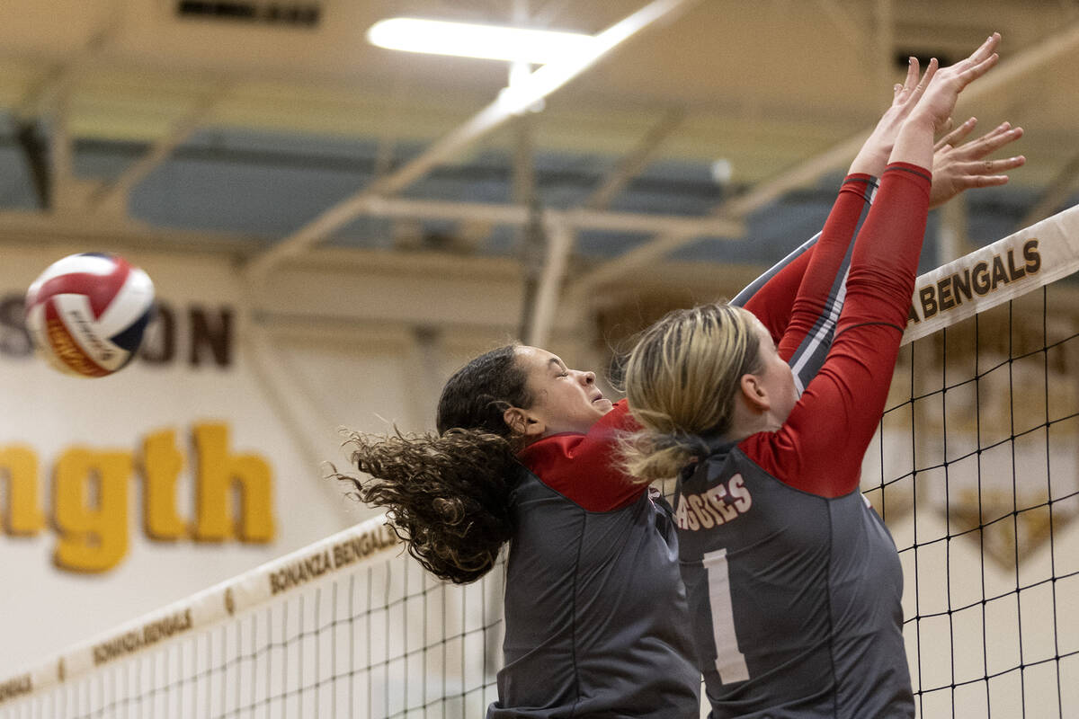 Arbor View’s Willow Watson, left, and Sarah Hoofman (1) miss a kill during a high school ...