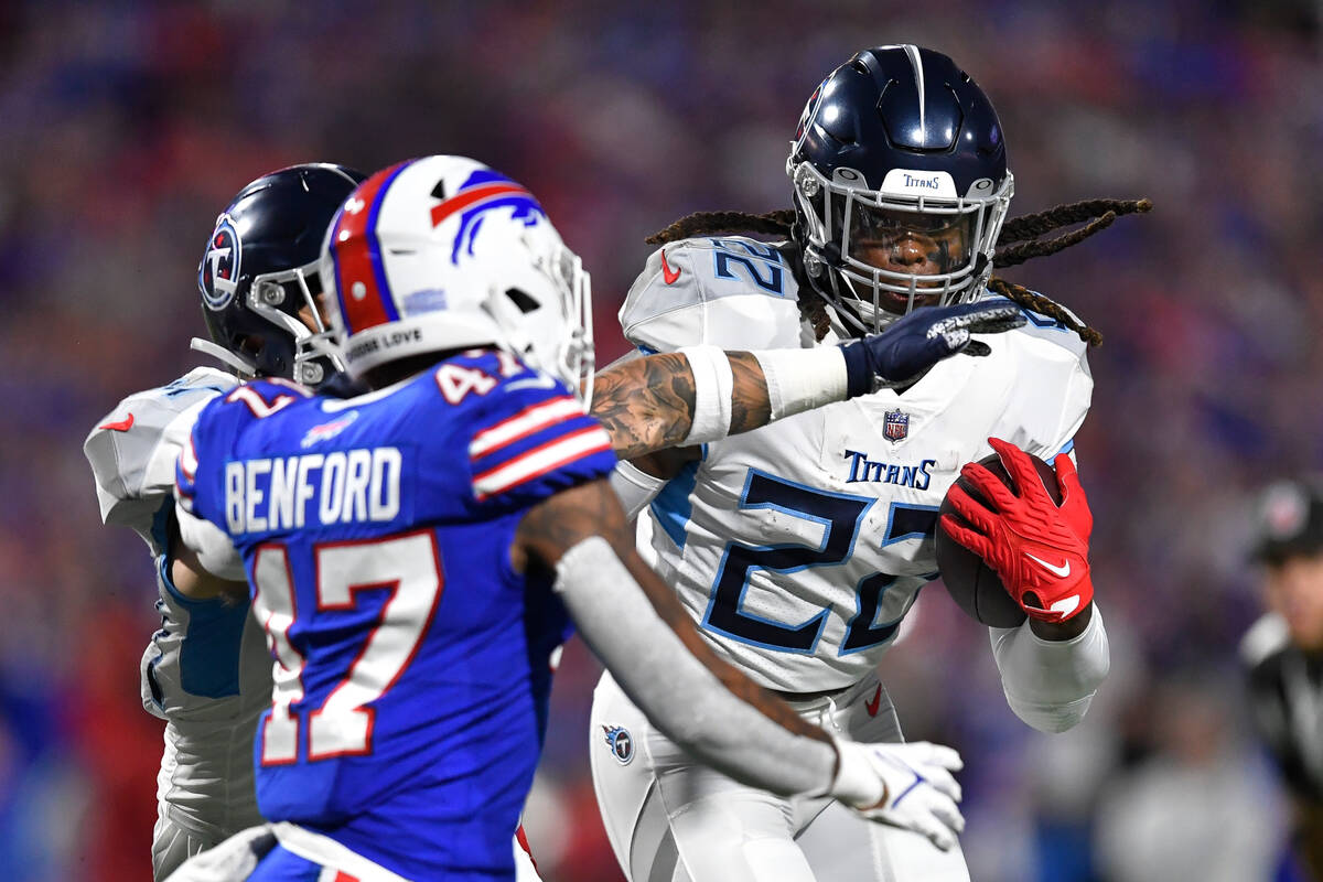 Tennessee Titans' Derrick Henry, right, rushes past Buffalo Bills cornerback Christian Benford ...