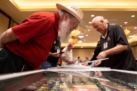 Mark Hall-Patton, retired Clark County Museum administrator, left, looks at poker chips for sal ...