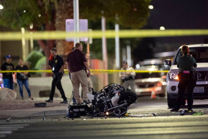 Las Vegas police investigate the scene of a crash involving a police motorcycle officer at the ...