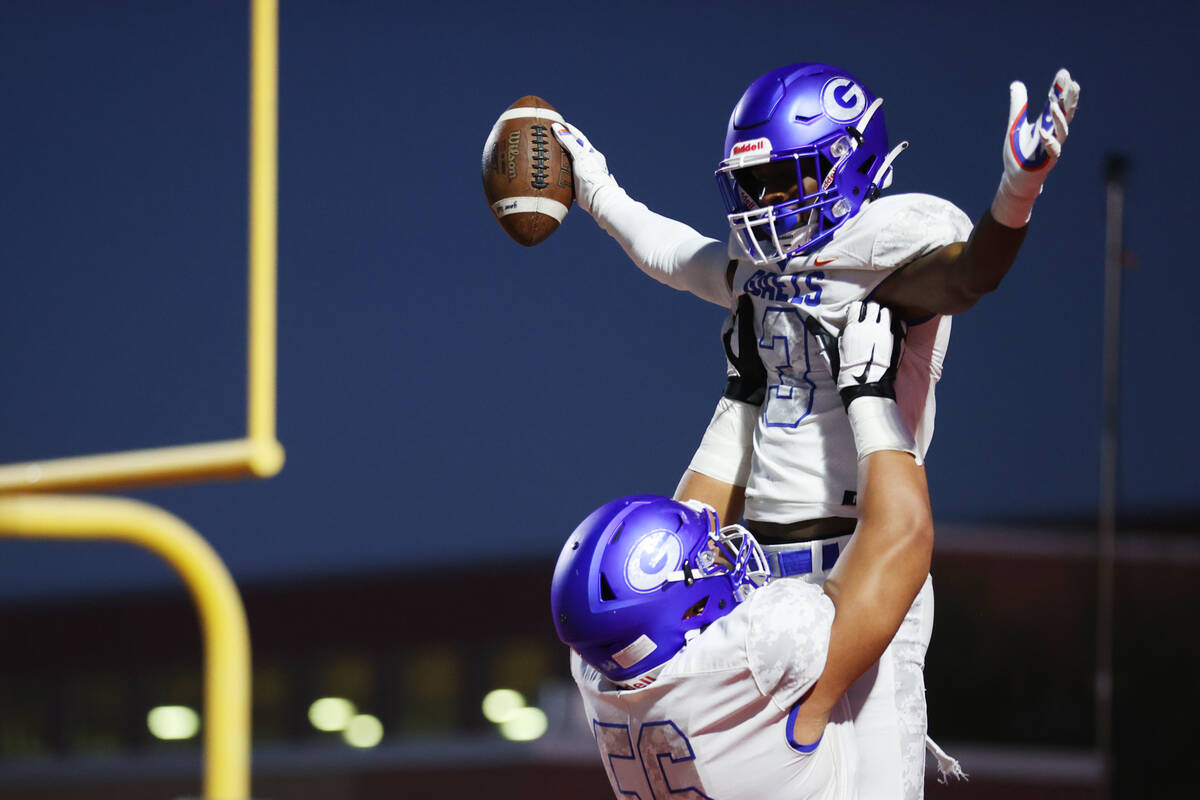 Bishop Gorman's Devon Rice (3) celebrates his touchdown run with Misiolo Maluia (56) against Ar ...