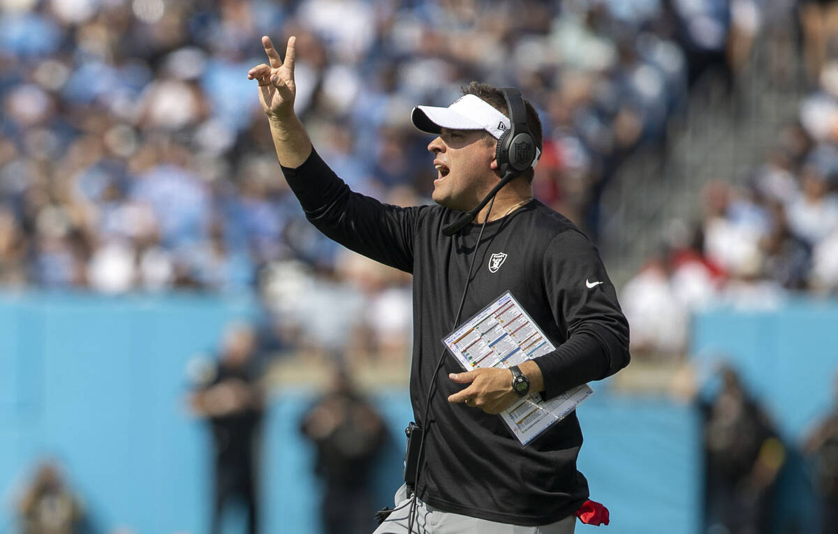 Raiders head coach Josh McDaniels holds up two fingers as he walks on the field during the seco ...
