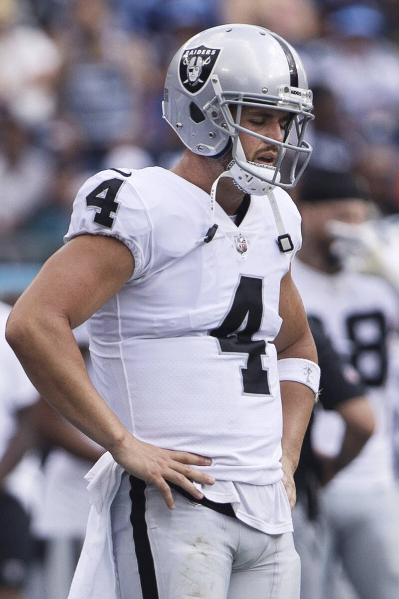 Raiders quarterback Derek Carr (4) stands on the sideline in contemplation during the second ha ...