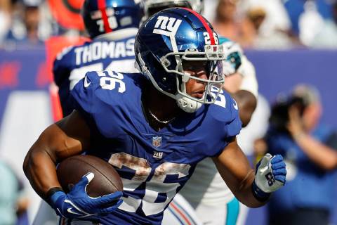 New York Giants running back Saquon Barkley runs against the Carolina Panthers during an NFL fo ...