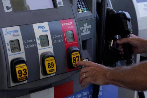 A customer pumps gas at an Exxon gas station, Tuesday, May 10, 2022, in Miami. (AP Photo/Marta ...