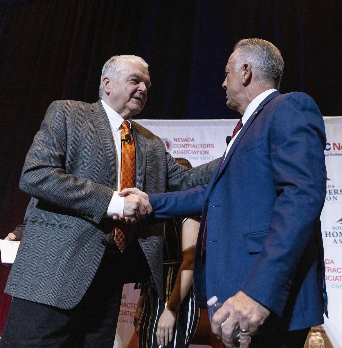 Gov. Steve Sisolak, left, and Sheriff Joseph Lombardo shake hands after meeting with the constr ...