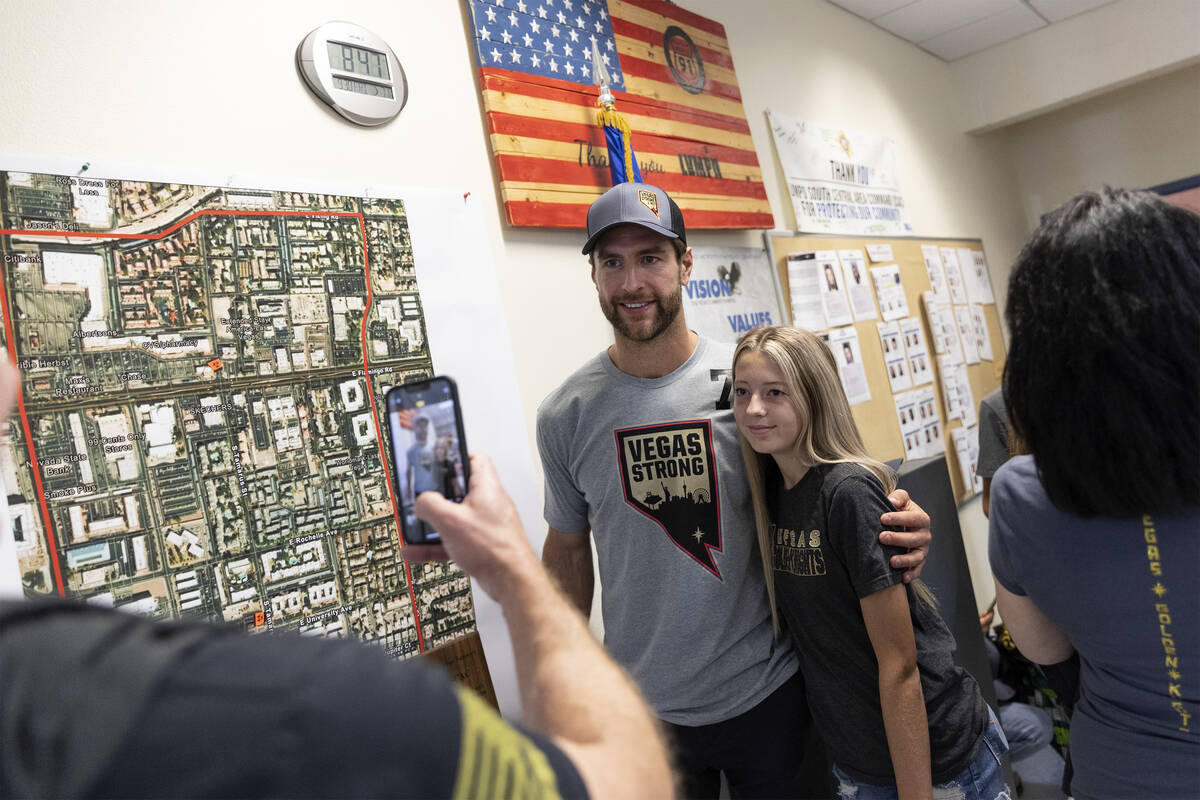 Dave Denton takes a photo of his daughter Taryn Denton, 16, with Golden Knights defenseman Alex ...