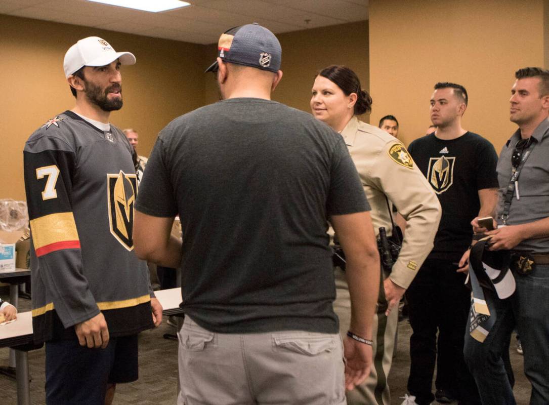 Vegas Golden Knights Jason Garrison (7) engages in conversation with William Castagnino, Jr. as ...