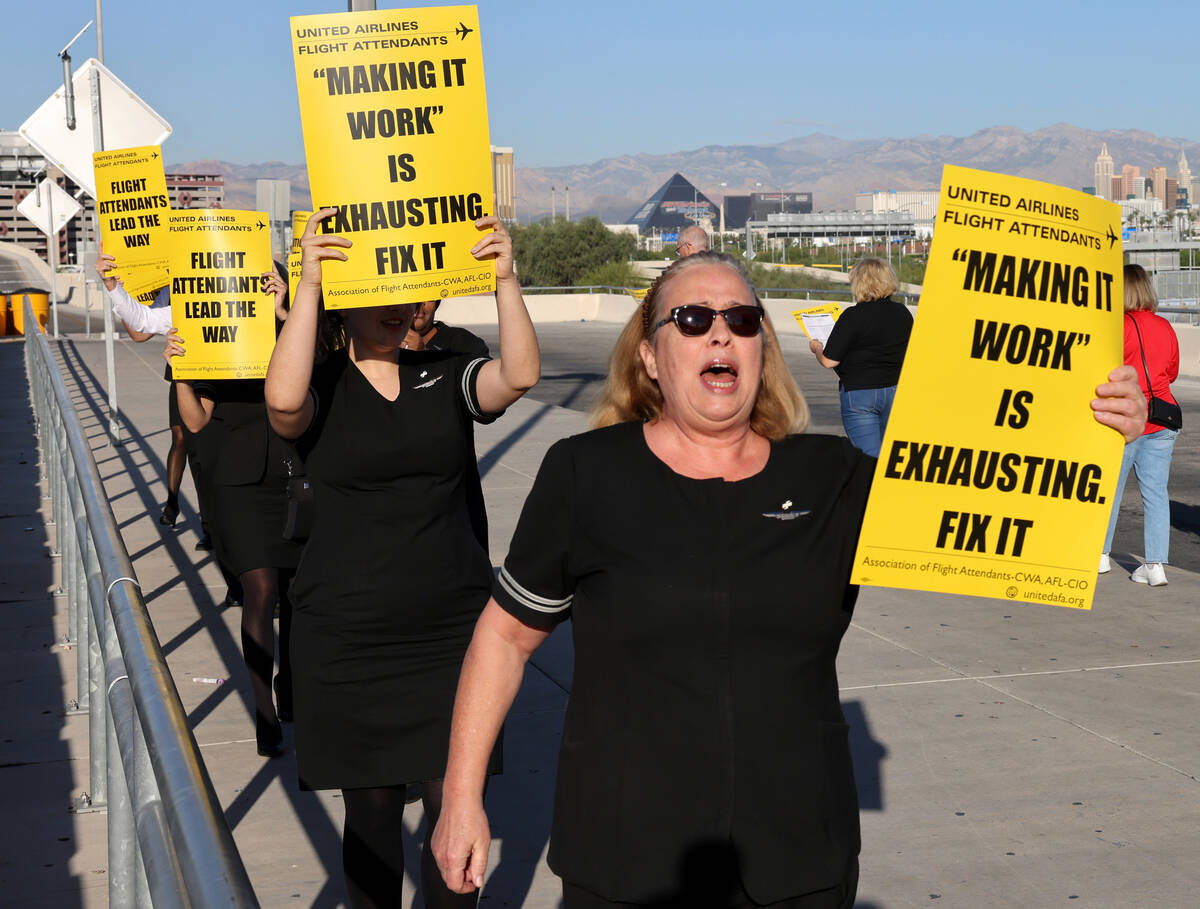 United Airlines flight attendants, including Laura Harsh, picket outside Terminal 3 at Harry Re ...