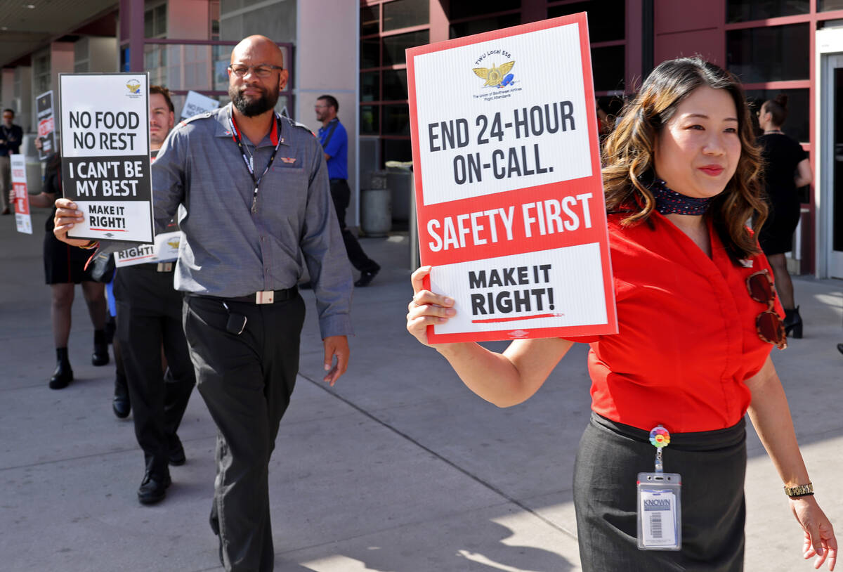 Southwest Airlines flight attendants, including Lisa Leong, picket outside Terminal 1 at Harry ...