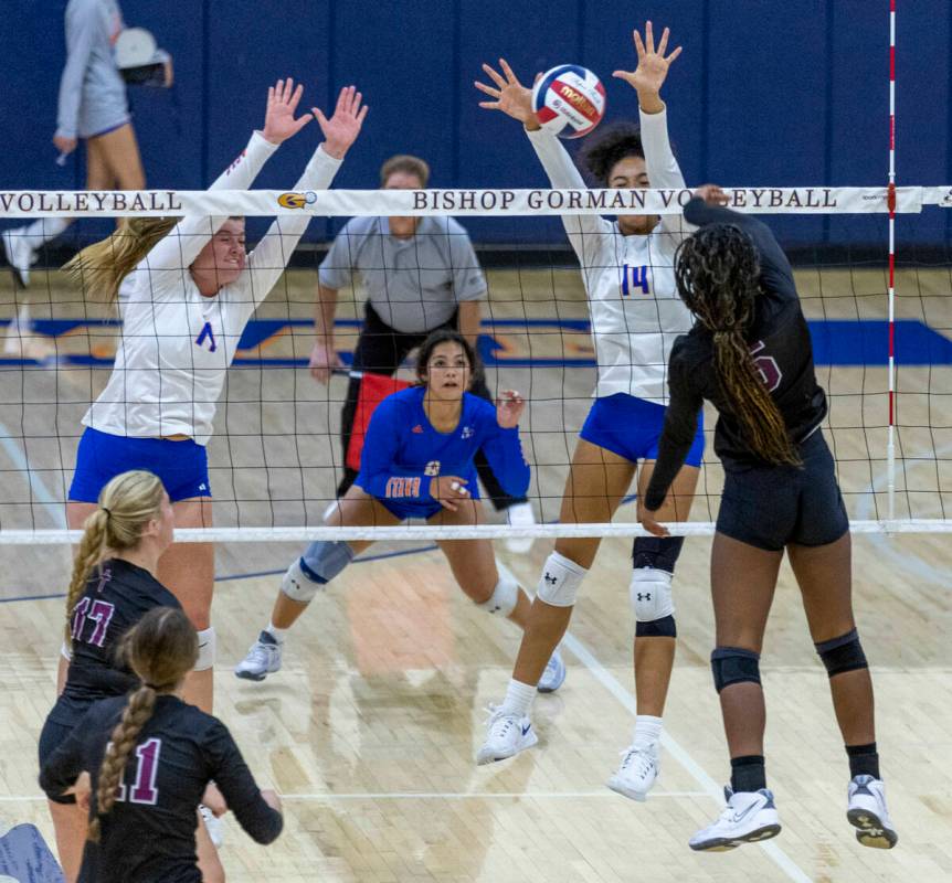 Bishop Gorman players look to block a shot by Faith Lutheran's Italya Cloyd (5) during the seco ...