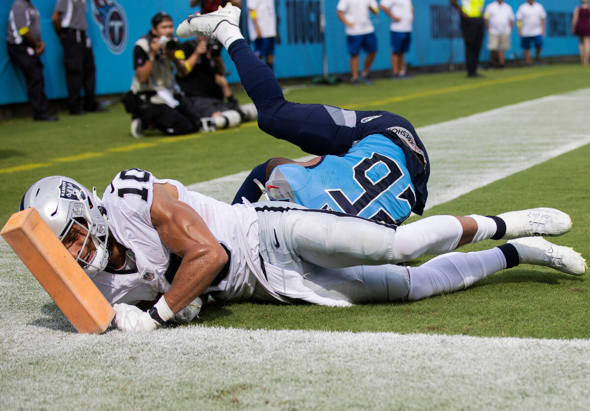 Raiders wide receiver Mack Hollins (10) collides with the end zone pylon with Tennessee Titans ...