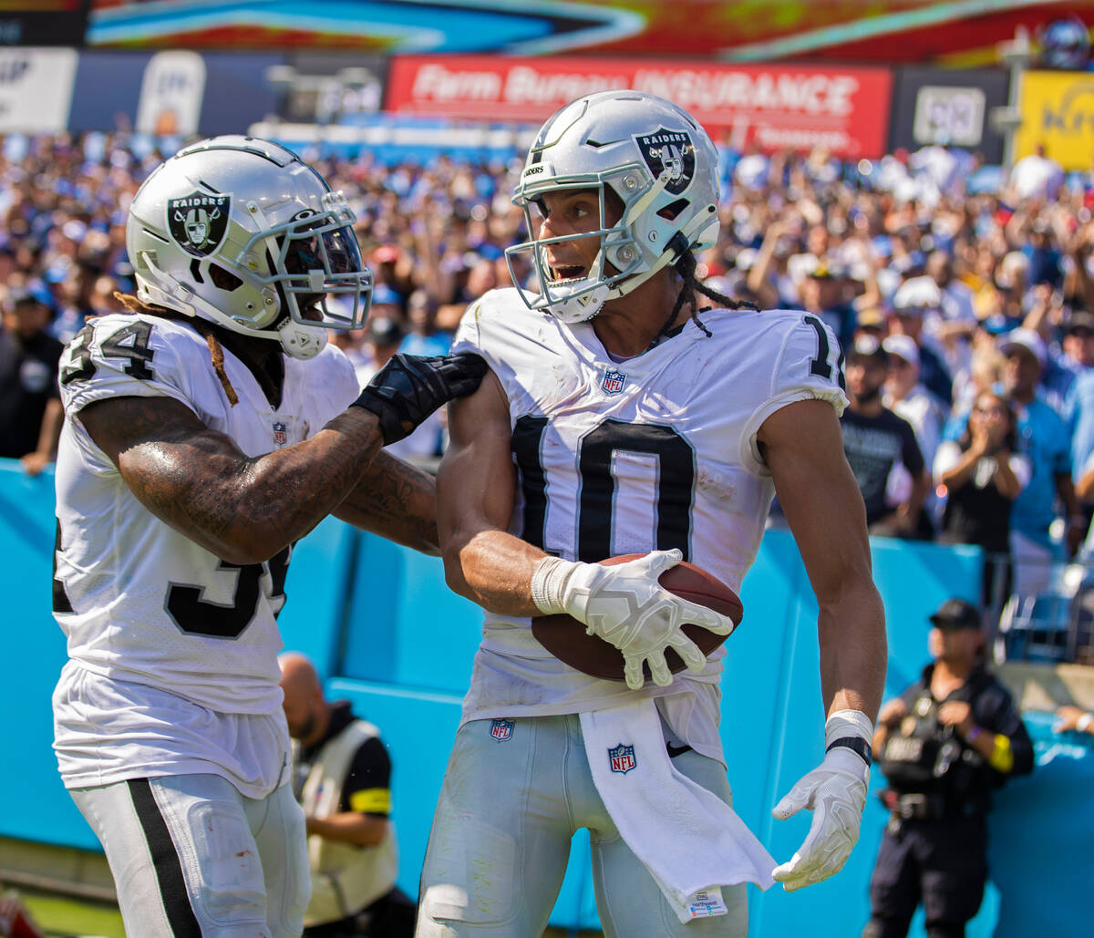 Raiders wide receiver Mack Hollins (10) celebrates a touchdown catch with Raiders running back ...