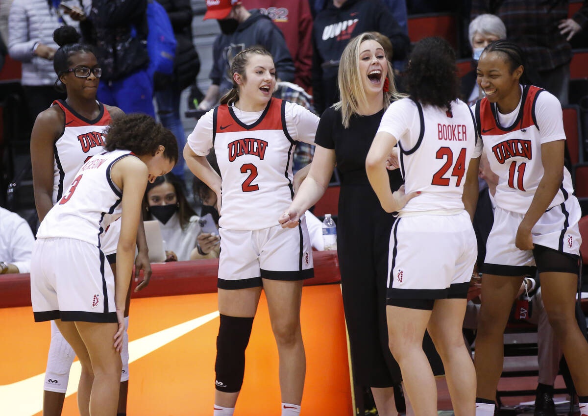 UNLV Lady Rebels head coach Lindy La Rocque shares a laugh with her players, guards Kenadee Win ...