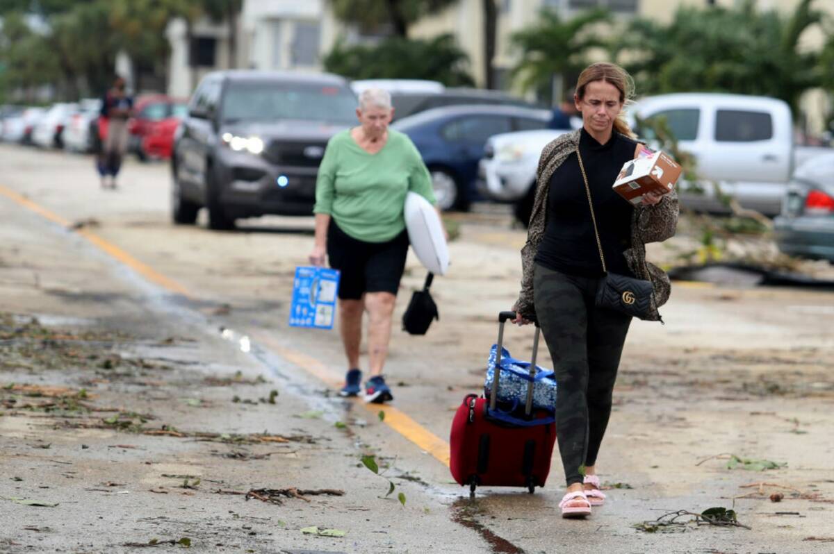 King Point residents leave with their belongings after an apparent overnight tornado spawned fr ...