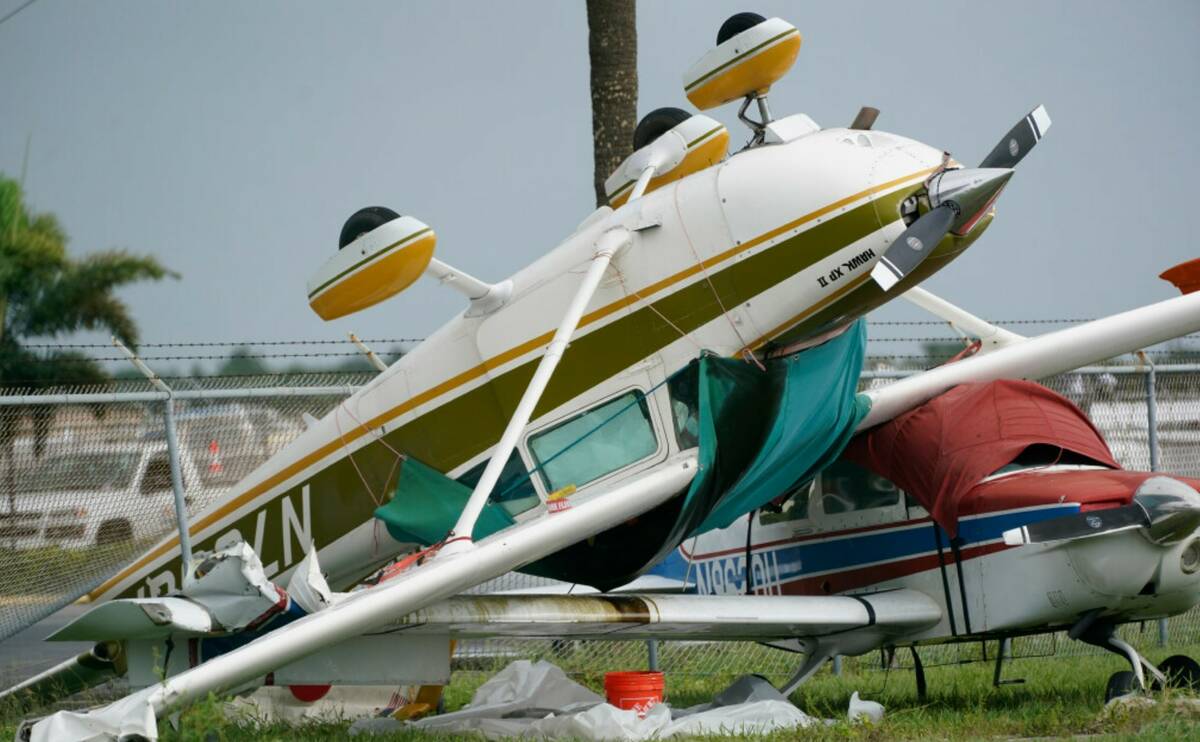 An airplane overturned by a likely tornado produced by the outer bands of Hurricane Ian is show ...