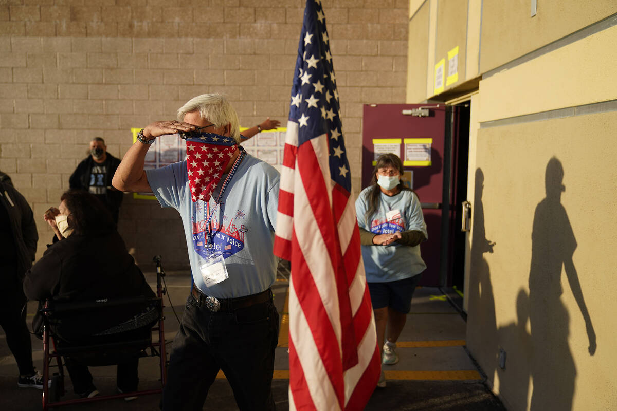 Poll workers prepare to open a polling place on Election Day, Tuesday, Nov. 3, 2020, in Las Veg ...