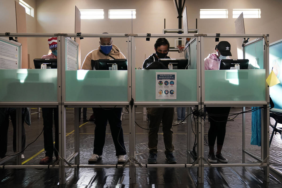 People vote at a polling place on Election Day, Tuesday, Nov. 3, 2020, in Las Vegas. (AP Photo/ ...
