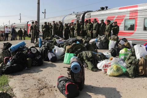 Russian recruits gather to take a train at a railway station in Prudboi, Volgograd region of Ru ...