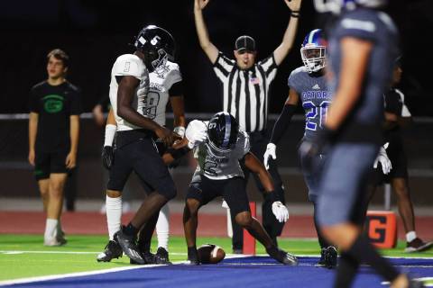 Desert Pines' Massiah Mingo (6) celebrates a touchdown against Green Valley in the first half o ...