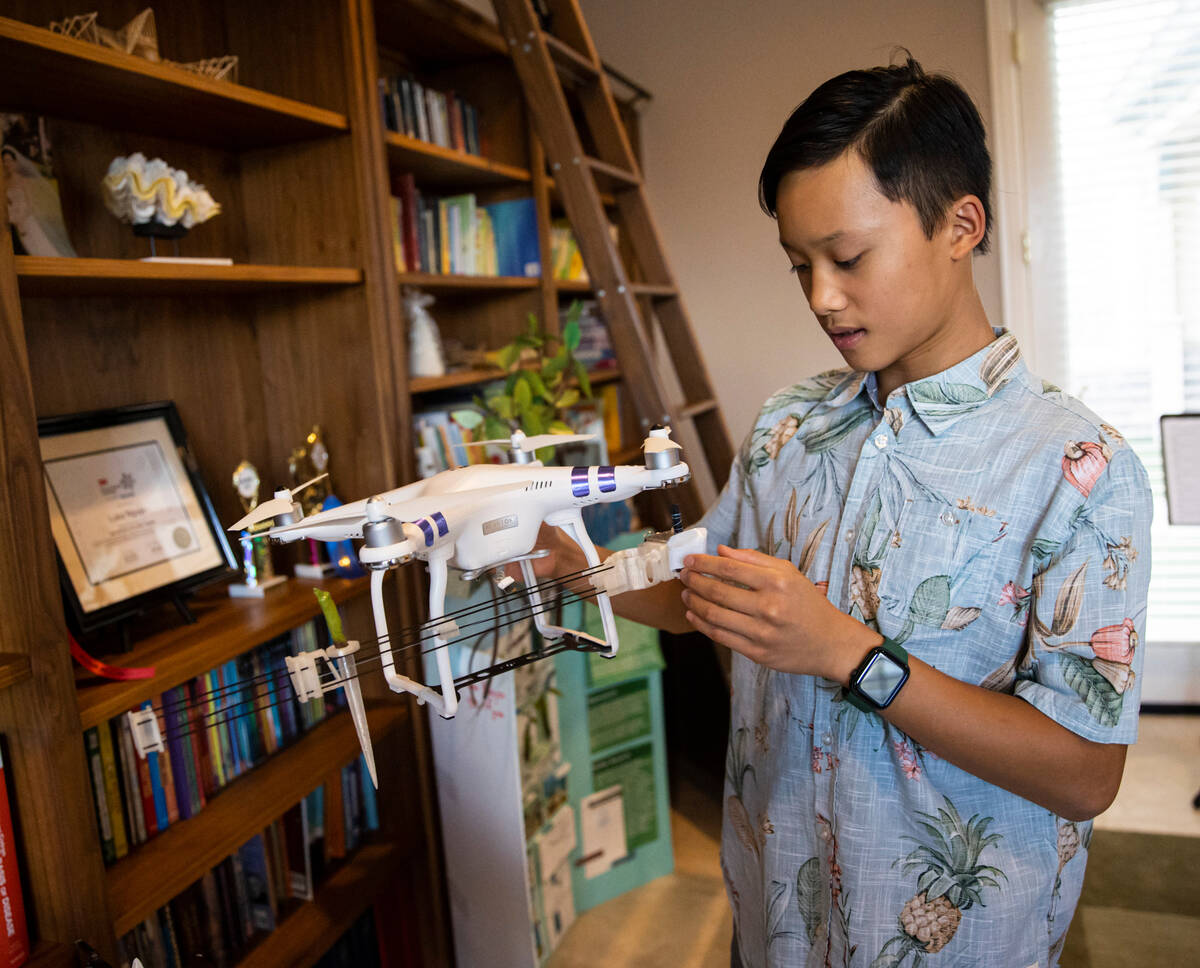 Luka Nguyen, 13, talks about his mangrove tree carbon sequestration project at his home on Oct. ...