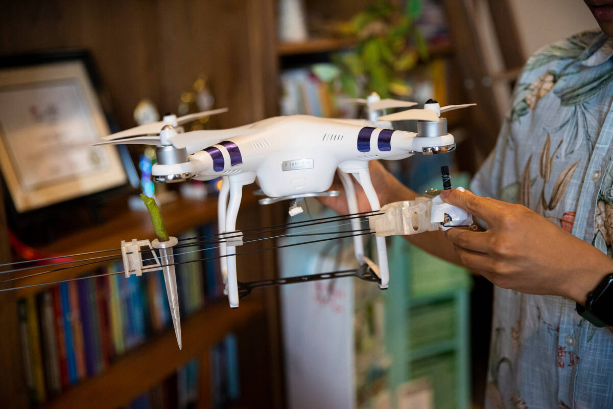 Luka Nguyen, 13, holds part of his award-winning science project at his home on Oct. 10, 2022, ...