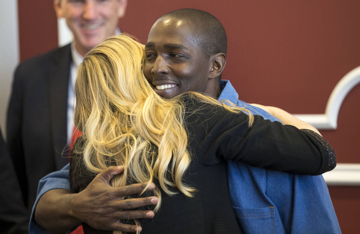 In this June 30, 2017, file photo, DeMarlo Berry hugs attorney Samantha Wilcox following a news ...