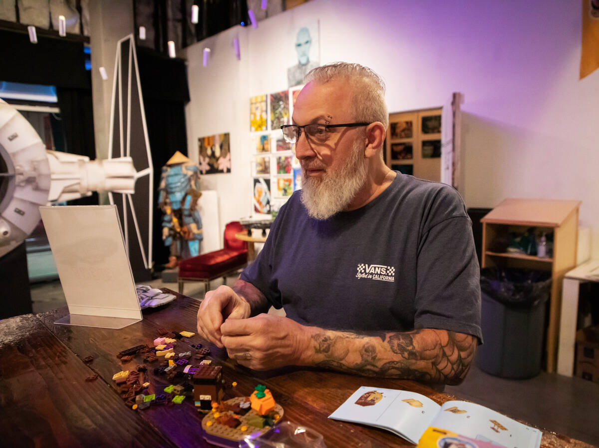 Steve Stephens works on a lego build at the Millenium Fandom Bar “Bricks n’ Booze ...