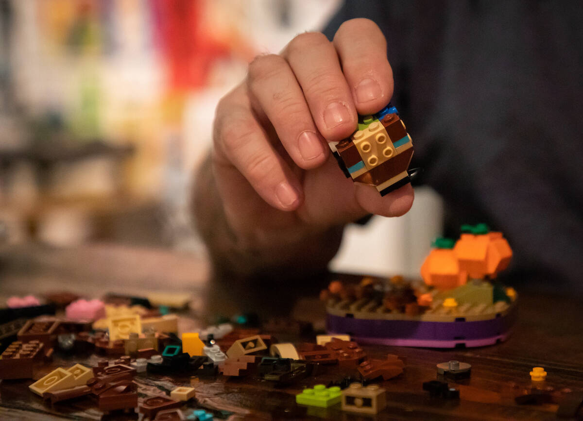 Steve Stephens works on a lego build at the Millenium Fandom Bar “Bricks n’ Booze ...